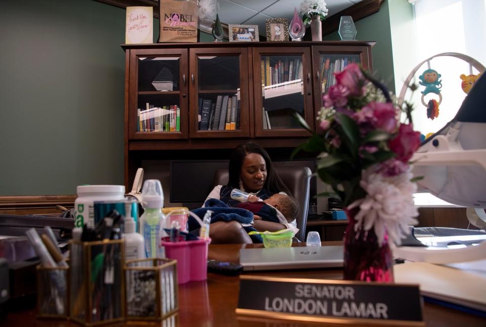 Sen. London Lamar D- Memphis, feeds her 7-month-old son Nylinn, while sitting at her desk in her office at Cordell Hull State Office Building in Nashville, Tenn., Wednesday, Feb. 14, 2024.