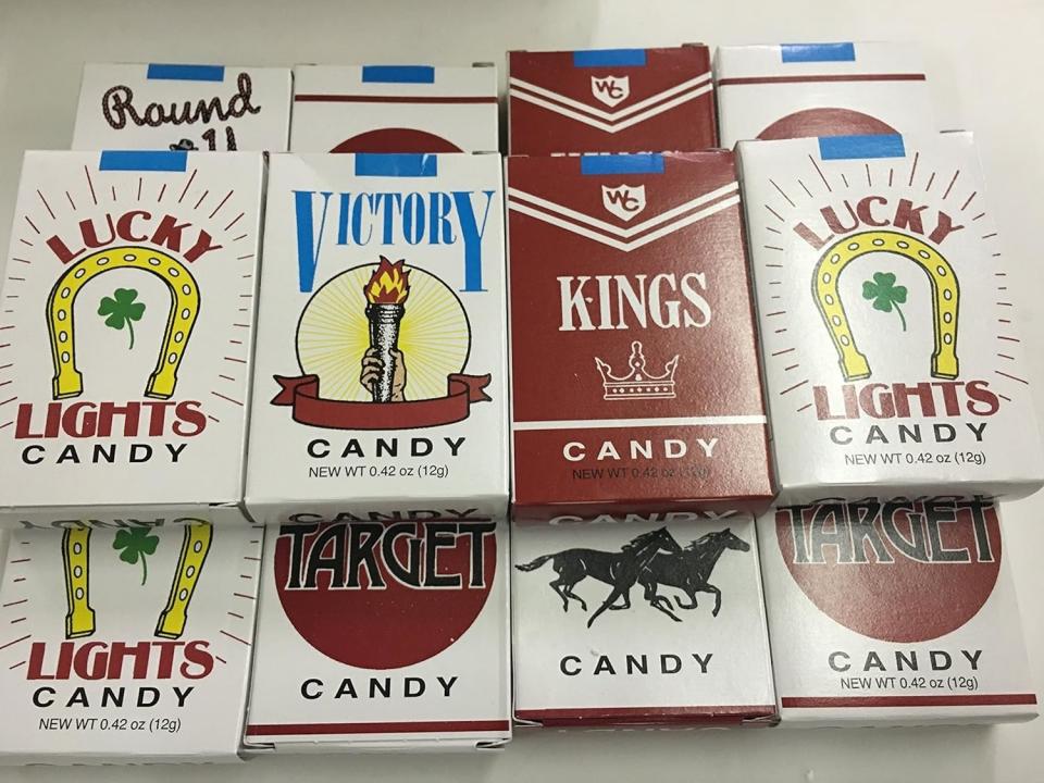 A collection of vintage candy packs resembling cigarette boxes labeled Lucky Lights, Victory, Kings, Target, and Target with a horse