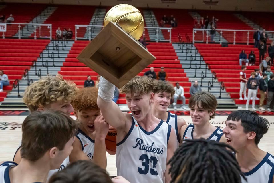 Raiders celebrate as champions of the 2023 IU Health Hoops Classic basketball tournament, West Lafayette vs Harrison, Saturday, Dec. 2, 2023, at Crawley Center in Lafayette, Ind. Harrison won 84-61.