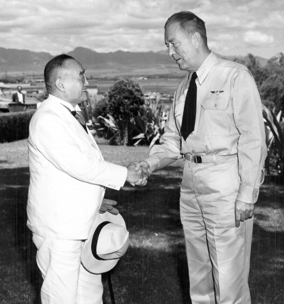 In this Sept. 12, 1951 photo provided by the U.S. Navy, Japanese Prime Minister Shigeru Yoshida, left, shakes hands with Adm. Arthur Radford, commander of the U.S. Pacific Fleet, at Radford's headquarters overlooking Pearl Harbor in Hawaii. Yoshida made the stop in Hawaii as he was traveling back to Japan from the San Francisco conference that restored Japan's sovereignty. Yoshida is best remembered for signing the San Francisco peace treaty with the U.S. and others in 1951, allowing Japan back into international society after its war defeat. His Pearl Harbor visit, which he made on his way home from San Francisco, was largely eclipsed by the historic treaty. (U.S. Navy via AP)