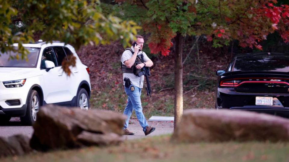 Police walk at the entrance to Neuse River Greenway Trail parking lot at Abington Lane in Raleigh, N.C., Thursday, October 13, 2022.