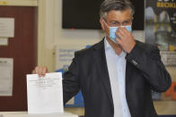 Andrej Plenkovic, Croatia's Prime Minister incumbent casts his ballot at a polling station in Zagreb, Croatia, Sunday, July 5, 2020. Amid a spike of new coronavirus cases, voters in Croatia cast ballots on Sunday in what is expected be a close parliamentary race that could push the latest European Union member state further to the right. (AP Photo)