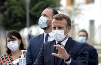 French President Emmanuel Macron gestures as he speaks to healthcare workers at the 'La Bonne Eure' nursing home in Bracieux, central France, Tuesday, Sept. 22, 2020. For the first time in months, virus infections and deaths in French nursing homes are on the rise again. (Yoan Valat/Pool Photo via AP)