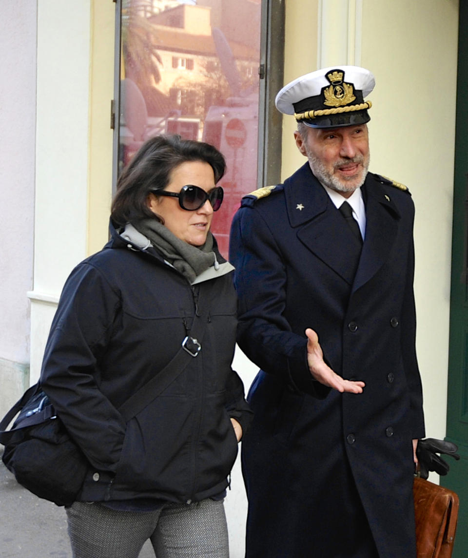 Coast Guard Capt. Gregorio De Falco, right, and his wife Raffaella arrive at the Grosseto court, Italy, Monday, Dec. 9, 2013. A Italian Coast Guard official has testified that hundreds of people were still aboard the shipwrecked Costa Concordia when the commander abandoned the cruise liner in a lifeboat. Coast Guard Capt. Gregorio De Falco become a national hero after repeatedly ordering Francesco Schettino, the Concordia's commander on trial for manslaughter and abandoning ship, to return to the badly listing vessel. Schettino is also charged with causing the 2012 shipwreck by sailing too close to the Tuscan island of Giglio. A reef gashed the hull, water rushed in and 32 people died. (AP Photo/Giacomo Aprili)