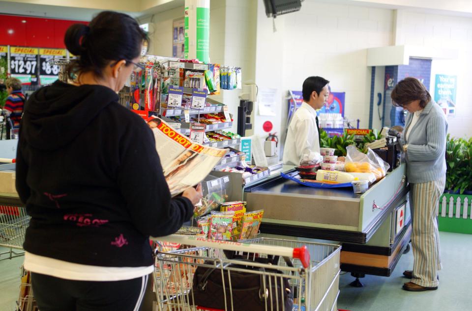 Woman standing in Woolworths checkout line. Source: Getty Images