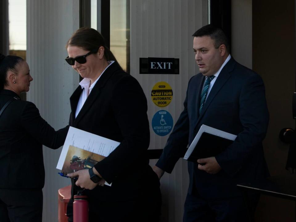 Const. Jessica Brown and Cpl. Randy Stenger, right, leave court in Edmonton. Brown and Stenger of the Whitecourt RCMP are charged with manslaughter in the 2018 death of Clayton Crawford, as well as aggravated assault and discharging a firearm with intent to cause bodily harm.  (Amber Bracken/The Canadian Press - image credit)