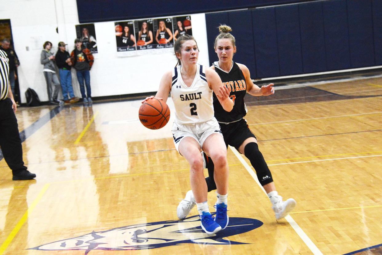 Sault High guard Mackenzie Bell (2) is defended by Rudyard's Tristin Smith during a Straits Area Conference girls basketball game Thursday night.