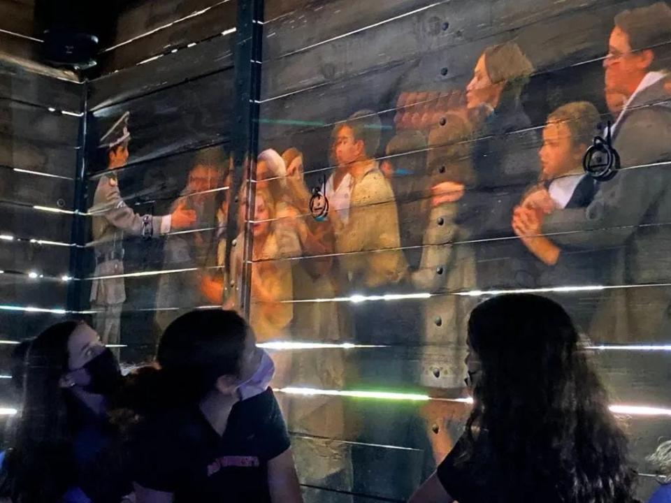 Students sit inside a traveling cattle car as part of a "Hate Ends Now" presentation earlier this year. The 360-degree video exhibit allows visitors to engage with history through video and audio remembering the Holocaust and featuring survivors’ testimonials.