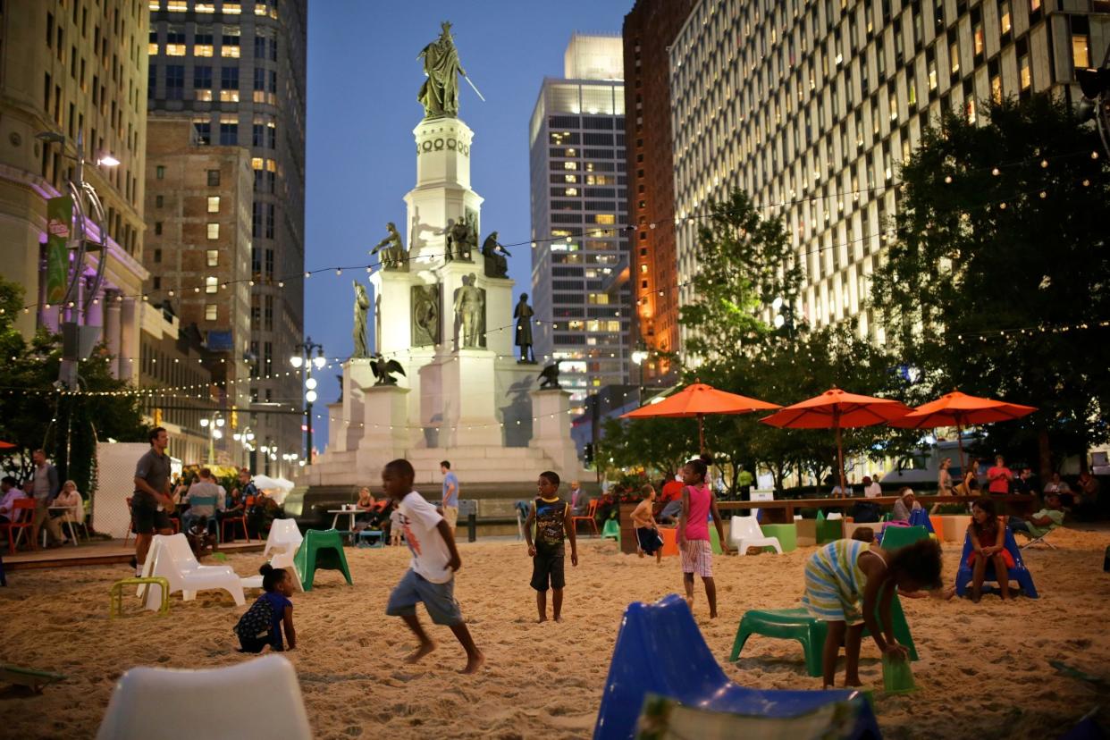 Kids play at the beach area on Campus Martius Park during the opening night of the Detroit Jazz Festival in Downtown Detroit on Friday, Sept. 4, 2015.