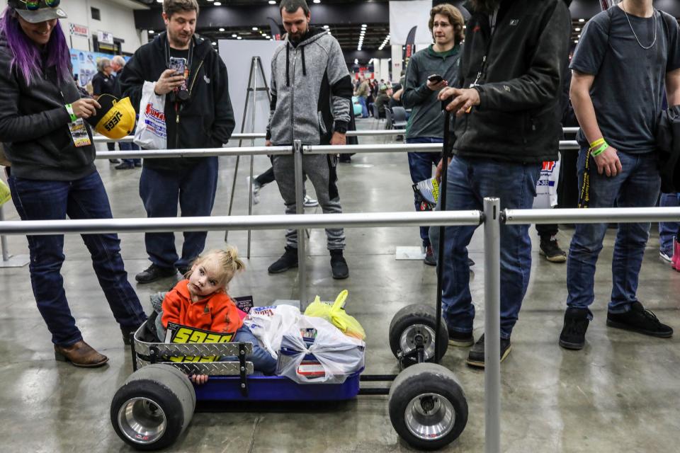 Scarlet Benkert, 2, of Waterford is pulled by her parents Kipp and Beth Benkert in a custom wagon, during the 69th annual Meguiar's Detroit Autorama at Huntington Place in downtown Detroit on Friday, March 4, 2022.  800 custom cars will be on display during the car show, including 30 cars competing for the prestigious Ridler Award.