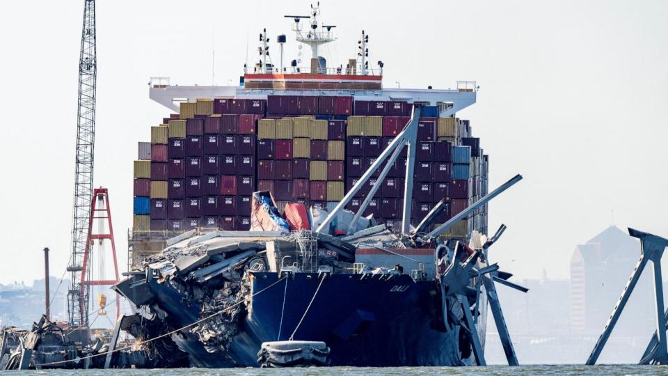 PHOTO: A section of the Francis Scott Key Bridge rests in the water next to the Dali container ship in Baltimore on May 13, 2024, after crews conducted a controlled demolition. (Roberto Schmidt/AFP via Getty Images)