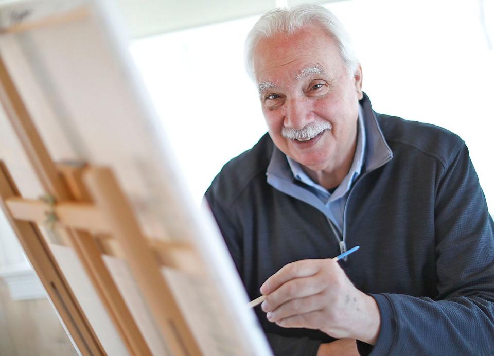 Frank Santoro, of Quincy, works on an acrylic painting on Tuesday, April 5, 2022.