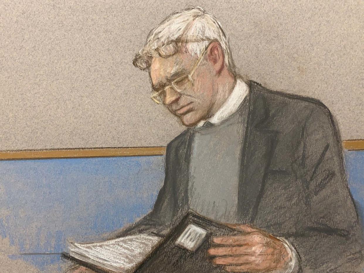 Julian Assange wearing two pair of glasses in seen at court during an extradition hearing: REUTERS