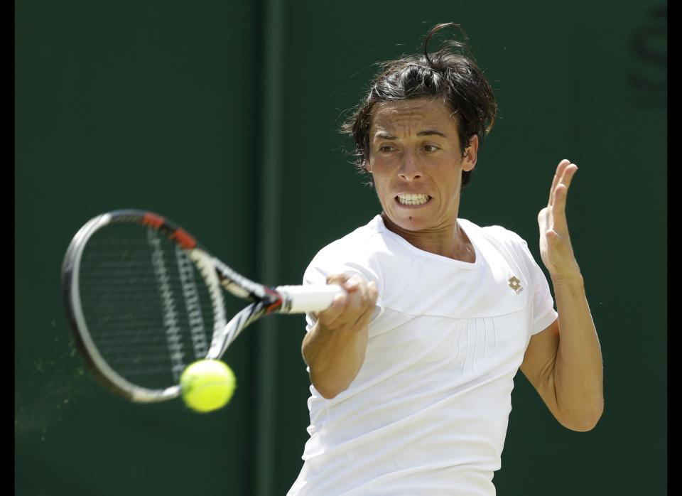 Francesca Schiavone of Italy returns a shot to Klara Zakopalova of the Czech Republic during a third round women's singles match at the All England Lawn Tennis Championships at Wimbledon, England, Saturday, June 30, 2012.