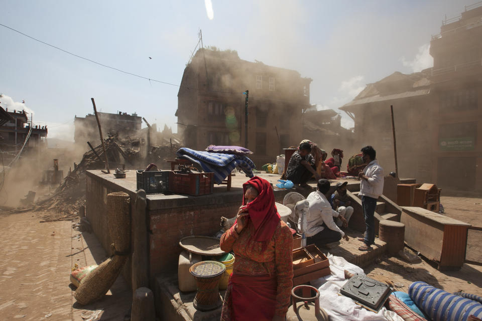 Nepalese residents gather in an open space at the site of destruction caused after Saturday's earthquake in Bhaktapur, on the outskirts of Kathmandu, Nepal, Monday, April 27, 2015. (AP Photo/Niranjan Shrestha)