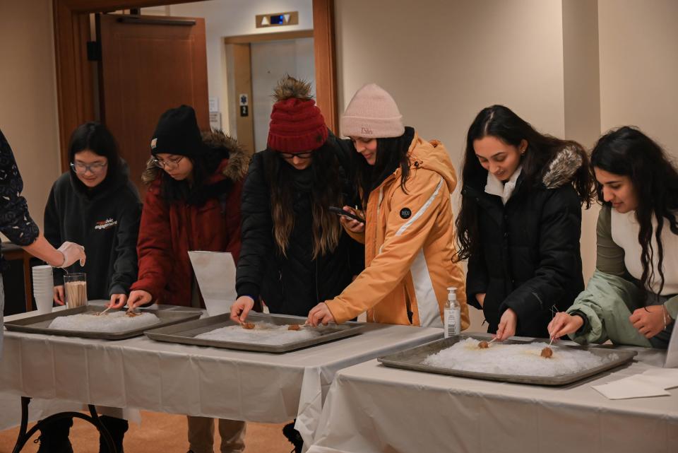 Participants make Canadian Maple Taffy using clean, fresh snow at the Wisconsin Union Winter Carnival.