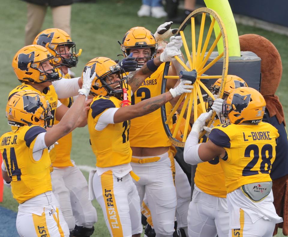 Kent State celebrates their 38-0 win over Akron to capture the Wagon Wheel on Saturday, Nov. 20, 2021 in Akron, Ohio, at InfoCision Stadium.