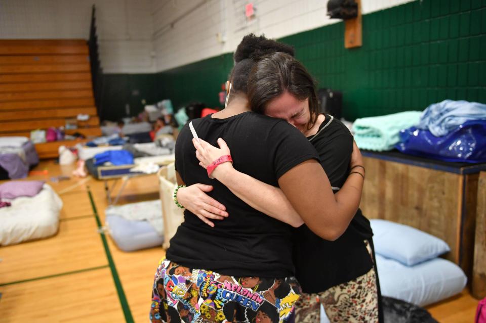 Stephanie Fopiano, right, gets a hug from Kenya Taylor, both from North Port, as she gets emotional about her situation at the Venice High School hurricane shelter in Venice, Florida, following Hurricane Ian on Monday, Oct. 3, 2022.  Fopiano, evacuated with her 68-year old mother before Hurricane Ian and is now at her third shelter in a week. Taylor, who was evacuated by airboat, said she is trying to stay strong and help the other people at the shelter with her. 