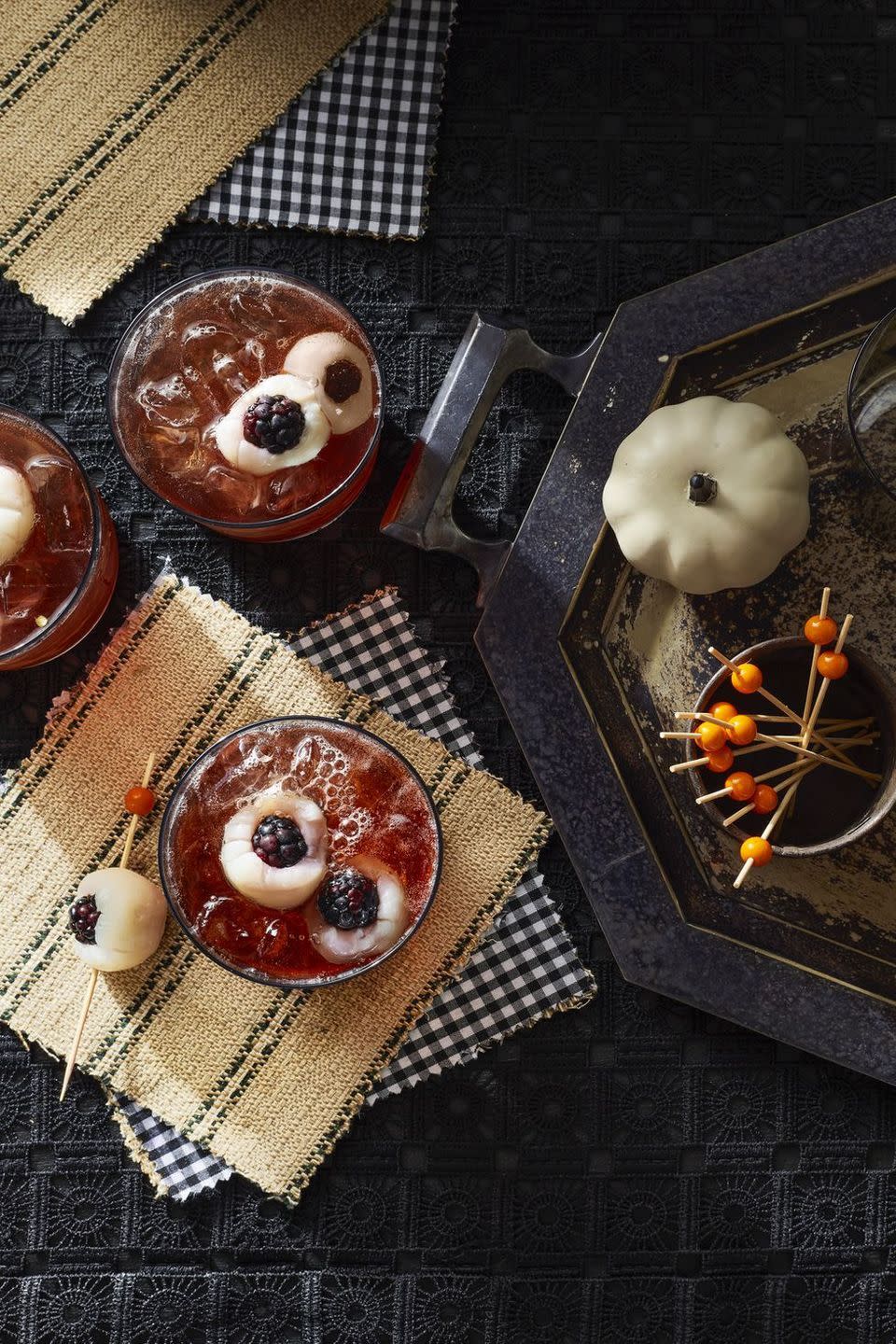 <p>I spy an eyeball in my drink! Have no fear, they're actually lychees stuffed with blueberries.</p><p>Get the <a href="https://www.countryliving.com/food-drinks/a36687070/tart-cherry-eyeball-punch/" rel="nofollow noopener" target="_blank" data-ylk="slk:Tart Cherry Eyeball Punch recipe;elm:context_link;itc:0;sec:content-canvas" class="link "><strong>Tart Cherry Eyeball Punch recipe</strong> </a>from Country Living. </p>