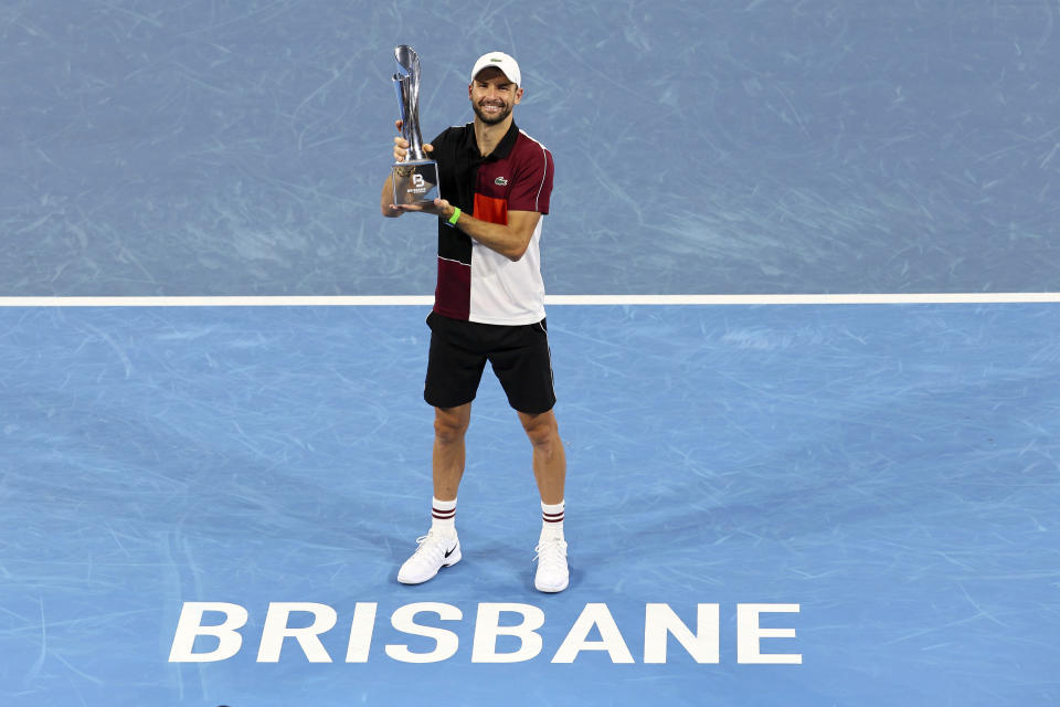 Grigor Dimitrov of Bulgaria poses with the trophy after he won his final match against Holger Rune of Denmark 6-3, 7-5, during the Brisbane International tennis tournament in Brisbane, Australia, Sunday, Jan. 7, 2024. (AP Photo/Tertius Pickard)