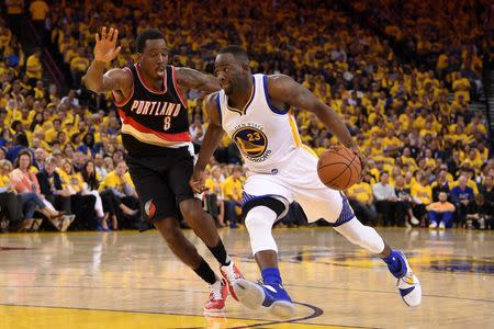 Golden State Warriors forward Draymond Green (23) dribbles the basketball against Portland Trail Blazers forward Al-Farouq Aminu (8) during the third quarter in game two of the second round of the NBA Playoffs at Oracle Arena. The Warriors defeated the Trail Blazers 110-99. Mandatory Credit: Kyle Terada-USA TODAY Sports