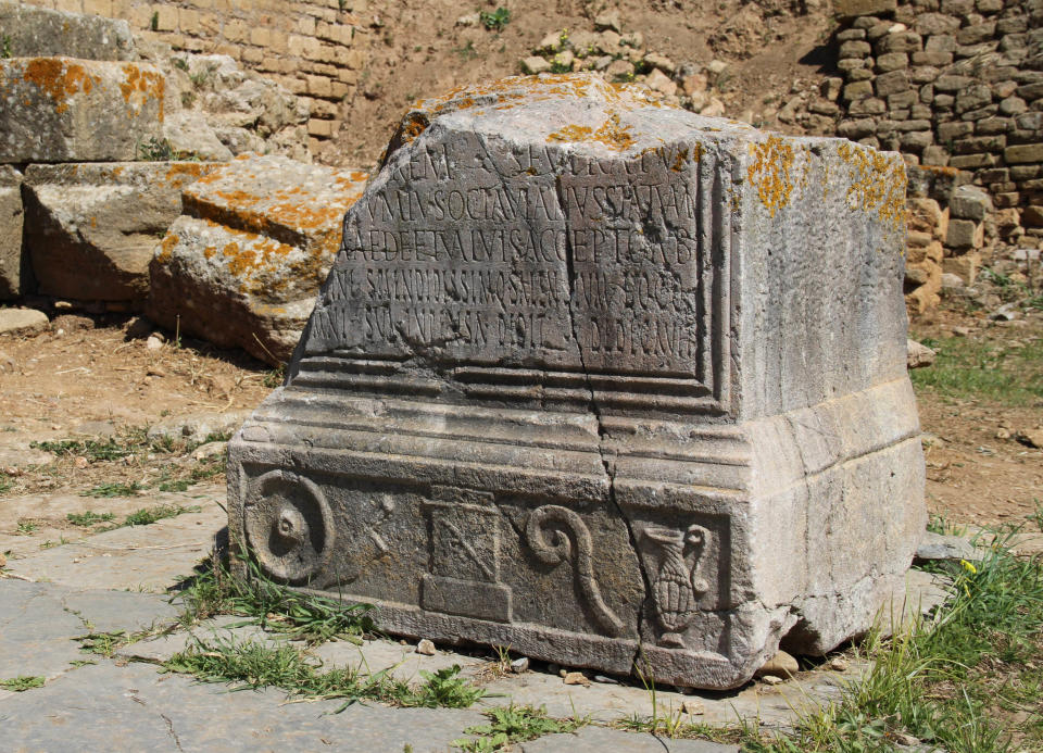 This March 10, 2012 photo shows a fragment of an engraved stone tablet resting in the forum of the ancient Roman city of Sala Colonia outside the Moroccan capital Rabat. (AP Photo/Paul Schemm)