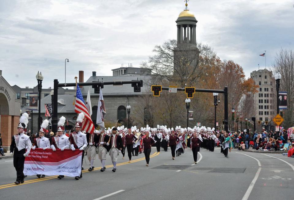 The UMass Amherst Marching Band makes its way through Quincy Center during the 69th annual Quincy Christmas Parade.
