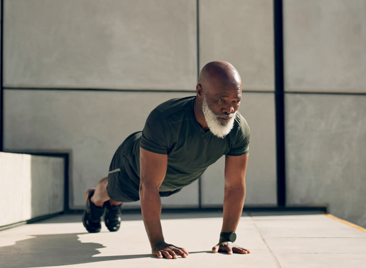 mature man doing pushups outdoors, concept of no-equipment workouts to rebuild strength