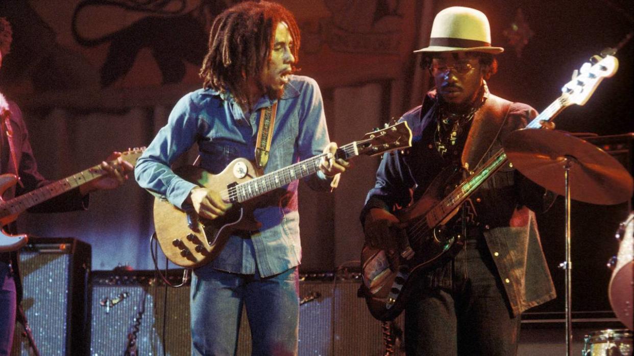  Photo of WAILERS and Aston BARRETT and Bob MARLEY, Bob Marley performing live on stage at the Odeon with Aston 'Family Man' Barrett 