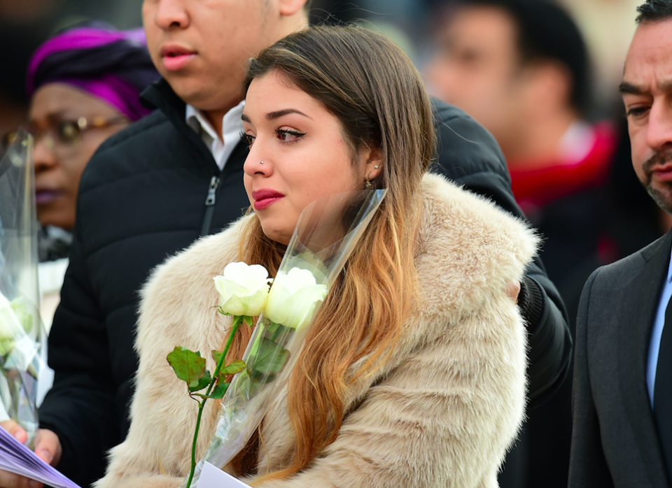 <em>Bereaved families and survivors held white roses as they left the service (PA)</em>