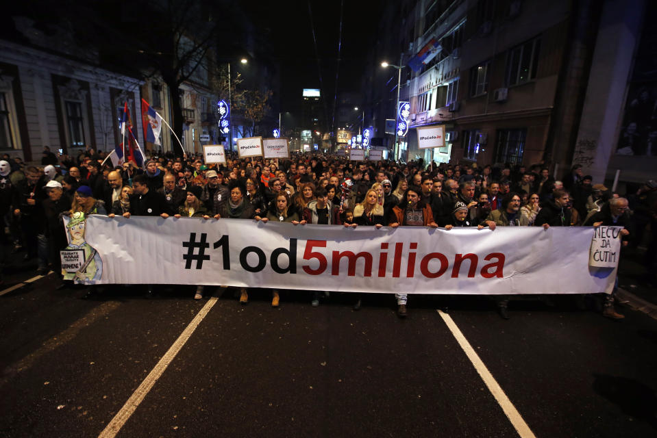 People hold a banner that reads: ''#1 out of 5 million'' during a protest against populist President Aleksandar Vucic in Belgrade, Serbia, Saturday, Dec. 22, 2018Thousands of people have rallied in another protest in Serbia against populist President Aleksandar Vucic accusing him of stifling hard-won democratic freedoms and cracking down on opponents. (AP Photo/Darko Vojinovic)