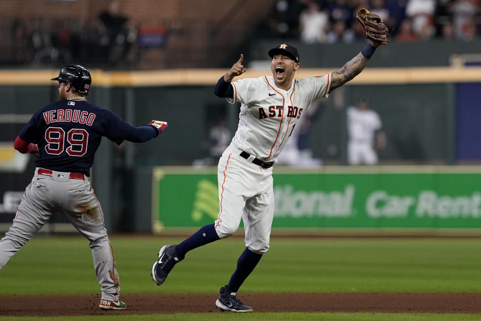 Houston Astros shortstop Carlos Correa celebrates after tagging out Boston Red Sox's Alex Verdugo at second to end the top of the seventh inning in Game 6 of baseball's American League Championship Series Friday, Oct. 22, 2021, in Houston. (AP Photo/Tony Gutierrez)