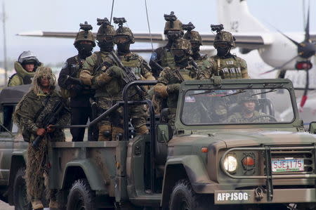 Soldiers on a vehicle participate in a parade during the 80th founding anniversary of the Armed Forces of the Philippines held inside Clark Air Base, formerly a U.S. base, in Angeles city, Pampanga province, north of Manila December 21, 2015. REUTERS/Romeo Ranoco