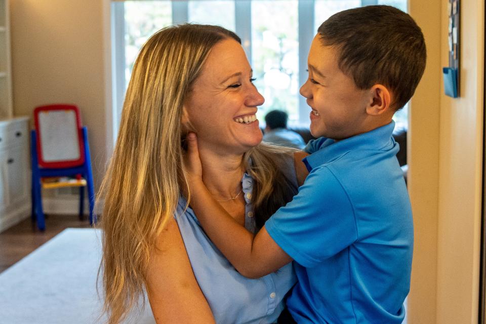 Kelly Castro holds her son Carson Castro at their Oradell home on Thursday, September 28, 2023. The Castro family started a business, Carson's Cookie Dough, to offer jobs to differently abled people. Carson has autism and is the motivation behind starting the company.