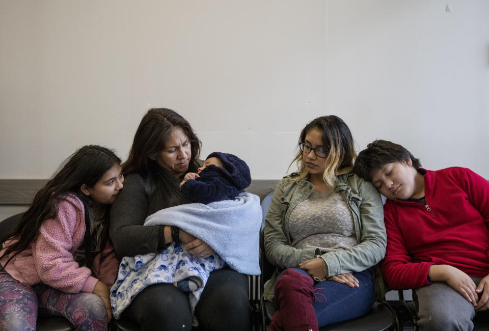 A family waits to visit a loved one at the Stewart Detention Center, Friday, Nov. 15, 2019, in Lumpkin, Ga. Once inside, visitors must: sign in; remove shoes and coats and go through a metal detector; lock their car keys and phone in a locker; and hand over their IDs, which are kept by security personnel until they leave. (AP Photo/David Goldman)