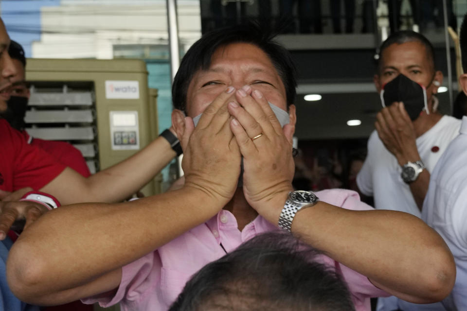 Presidential candidate Ferdinand "Bongbong" Marcos Jr. gestures as he greets the crowd outside his headquarters in Mandaluyong, Philippines on Wednesday, May 11, 2022. Marcos' apparent landslide victory in the Philippine presidential election is raising immediate concerns about a further erosion of democracy in Asia and could complicate American efforts to blunt growing Chinese influence and power in the Pacific. (AP Photo/Aaron Favila)