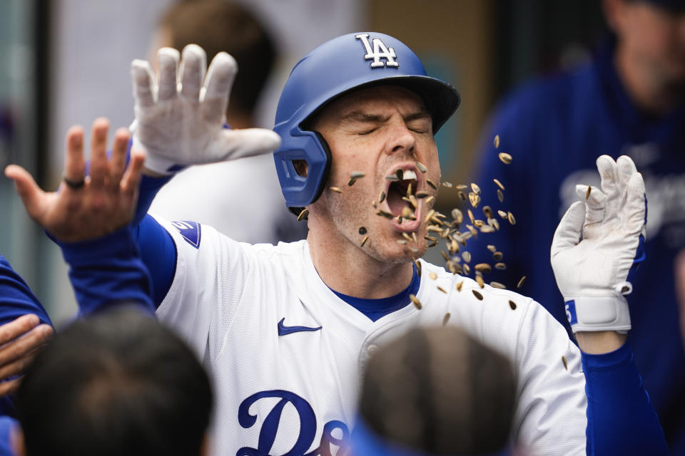 Los Angeles Dodgers' Freddie Freeman celebrates in the dugout after hitting a home run during the first inning of a baseball game against the Colorado Rockies in Los Angeles, Sunday, June 2, 2024. (AP Photo/Ashley Landis)