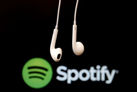 FILE PHOTO: Headphones are seen in front of a logo of online music streaming service Spotify, February 18, 2014 REUTERS/Christian Hartmann/File Photo