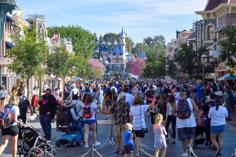 Visitors to Disneyland walk up Main Street U.S.A. just after the resort's gates opened in Anaheim, CA, on April 30, 2021. Jeff Gritchen/Orange County Register via ZUMA/dpa