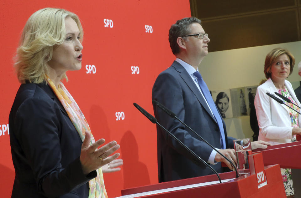 The three interim leaders of German Social Democrats, SPD, Manuela Schwesig, Thorsten Schaefer-Guembel and Malu Dreyer talk to the press in Berlin, Germany, Monday, June 24, 2019. The Social Democrats are in a poll slump and rudderless after leader Andrea Nahles quit following the party's battering in last month's European Parliament election. So far, no one has declared their candidacy for the notoriously difficult job — and the three deputy leaders who have taken the reins jointly on an interim basis have all ruled themselves out. (Wolfgang Kumm/dpa via AP)