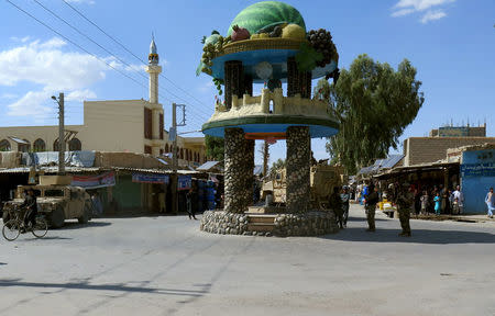 U.S troops keep watch during an official visit at the main square in Farah province, Afghanistan May 19, 2018. REUTERS/James Mackenzie