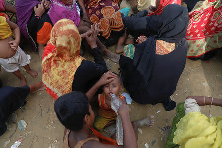 Rohingya refugees wait for humanitarian aid to be distributed at a camp for those who recently fled from Myanmar, near Cox's Bazar, Bangladesh October 5, 2017. REUTERS/Damir Sagolj