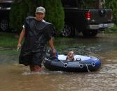 <p>John Tuan returns to rescue his dog who was left in his flooded house in the Clodine district after Hurricane Harvey caused heavy flooding in Houston, Texas on Aug. 29, 2017. (Photo: Mark Ralston/AFP/Getty Images) </p>