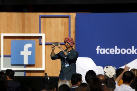 An attendee wearing a turban takes a picture before Indian Prime Minister Narendra Modi arrives for a town hall at Facebook's headquarters in Menlo Park, California September 27, 2015. REUTERS/Stephen Lam