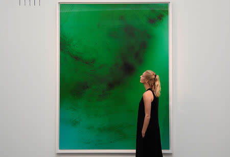 FILE PHOTO: An employee poses next to 'Frieschwimmer 193' by Wolfgang Tillmans, at Sotheby's in London, Britain, October 12, 2017. REUTERS/Toby Melville/File Photo