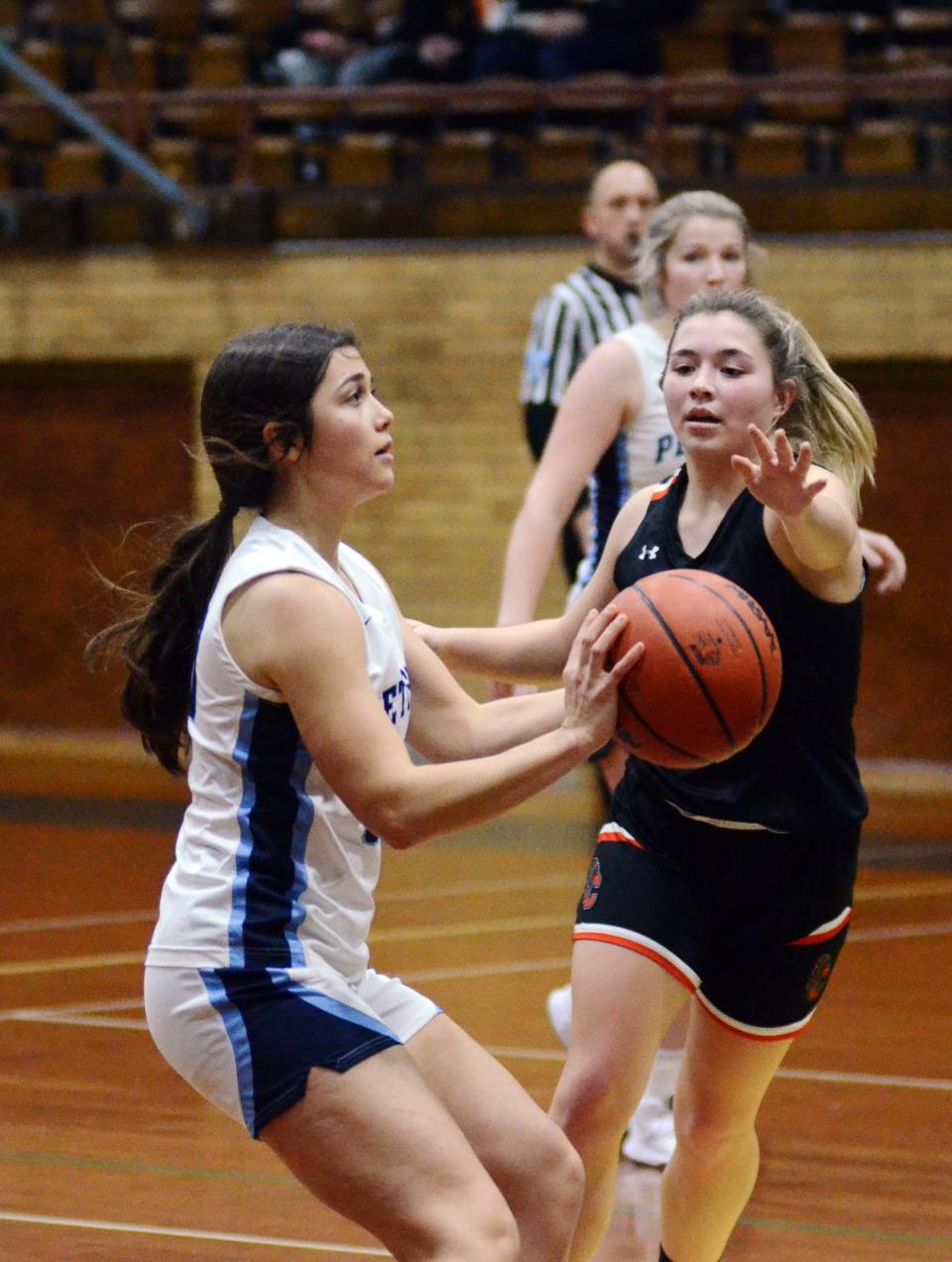 Petoskey's Ellie Stolzenfels pulls up for a jumper before Cheboygan's Cassidy Jewell runs in.
