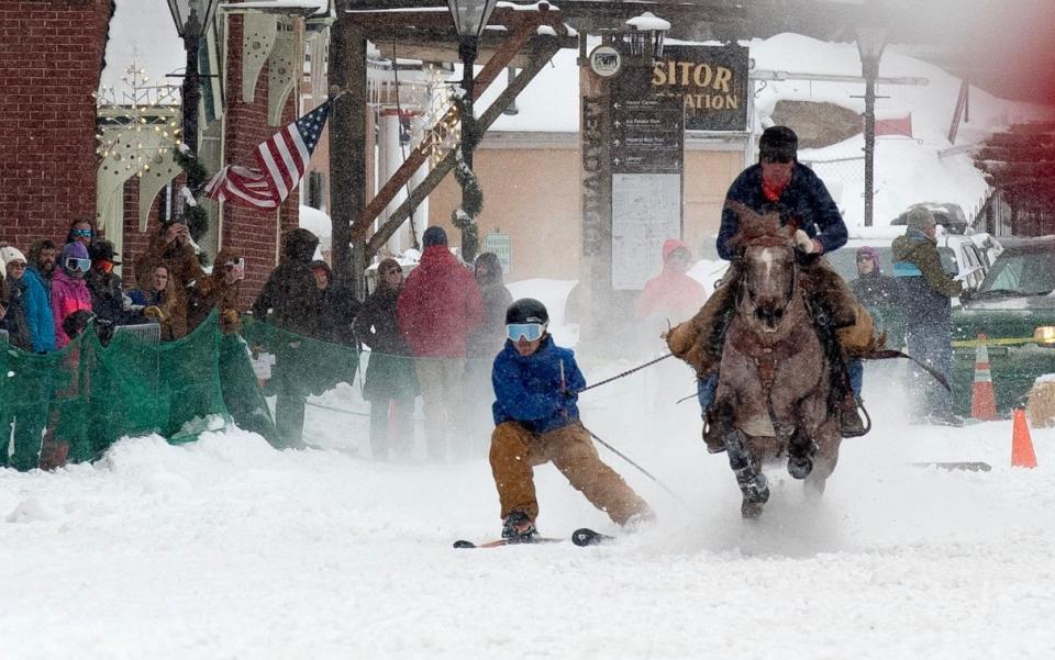 One rider clings to their rope as they are pulled along at high speeds