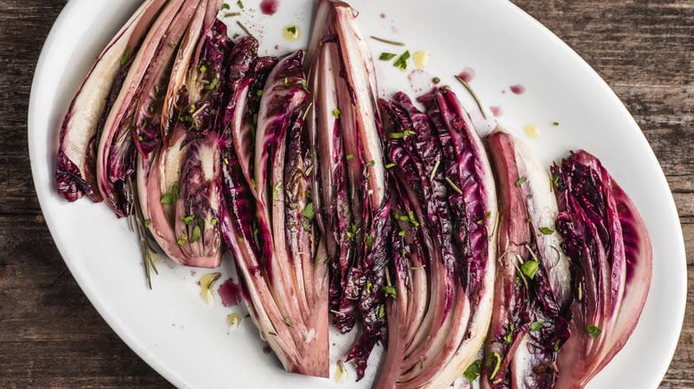 roasted radicchio on white plate atop rustic table 