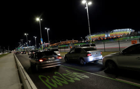 Cars drive in front of 2016 Rio Olympic Park in Rio de Janeiro, Brazil, July 31, 2016. REUTERS/Ricardo Moraes