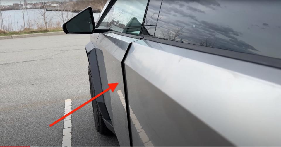 A red arrow pointing to a door panel gap on a Cybertruck.